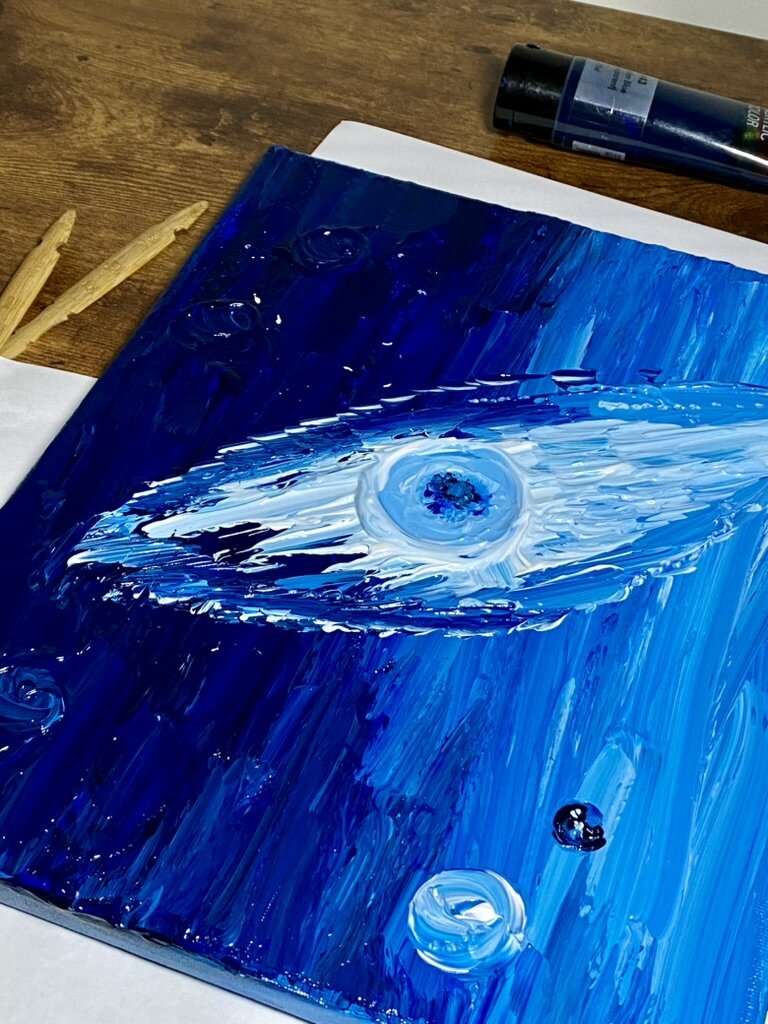 Painting of a blue galaxy.